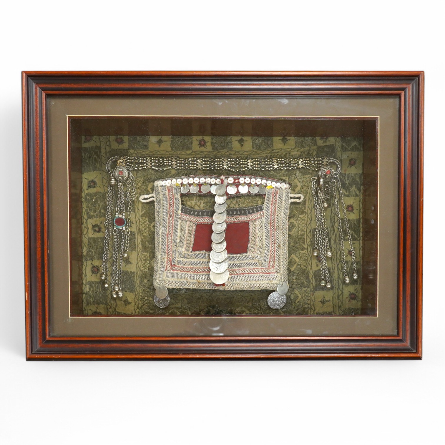 A framed Omani tribe wedding veil, 45 x 62cm. Condition - good